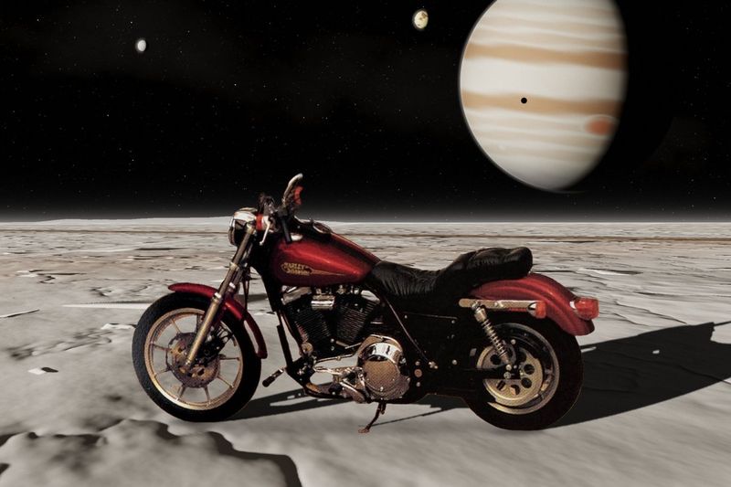 A red FXRS parked on an icy moon under Jupiter, a composite image. Not the bike for sale.