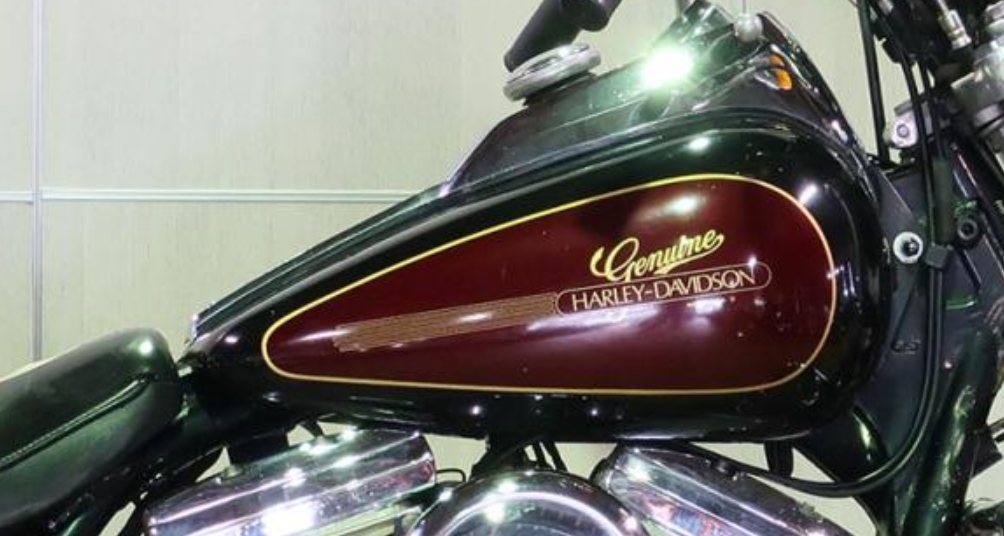 The original: an owner's 1984 FXRDG tank in burgundy with the gold script, oval, speed lines and pinstripe